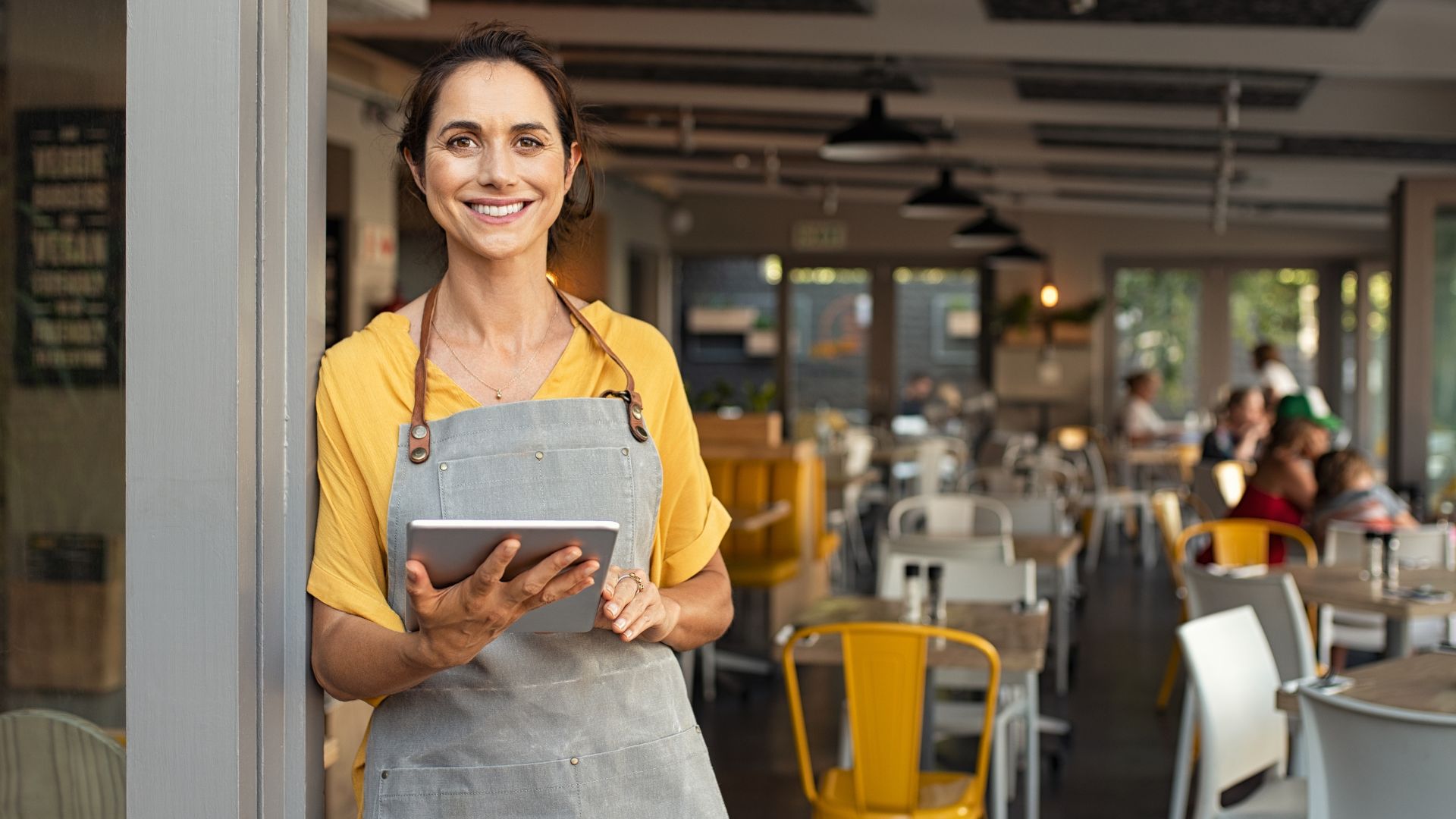 Small business owner reviewing business credit on a tablet